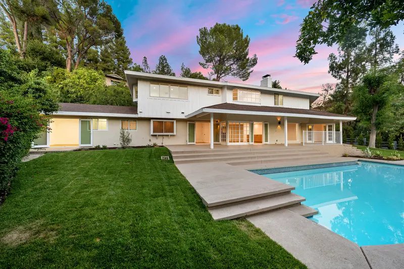 Exterior house painting for modern two-story home with pool