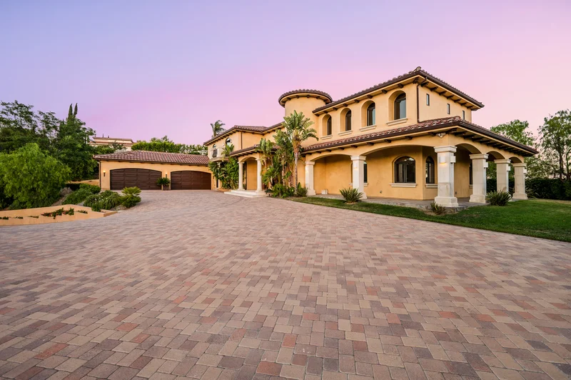 Mediterranean style villa exterior paint job with paved driveway Mediterranean style villa exterior paint job with paved driveway
