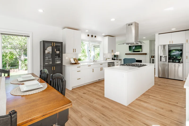 Modern white kitchen remodel with island and hardwood floors Modern white kitchen remodel with island and hardwood floors