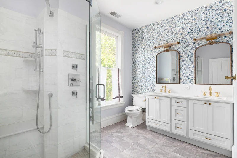 Bathroom remodeling service with elegant blue patterned wallpaper.